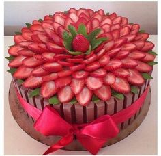 a chocolate cake decorated with fresh strawberries