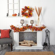 the fireplace is decorated with fall leaves and candles