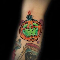 a person with a tattoo on their arm has a jack - o'- lantern