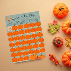 an autumn activity book with pumpkins and leaves on the table next to it,