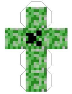 an image of a cross made out of green paper with black dots on the top