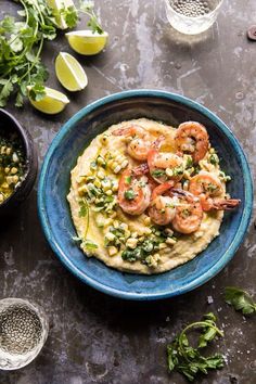 a blue bowl filled with shrimp and grita