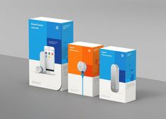 three different boxes with an electronic device in them and the packaging is white, orange, and blue