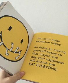 someone is holding an open book with a smiley face on it and the words you can't make everyone happy, so focus on making yourself happy so that maybe one day