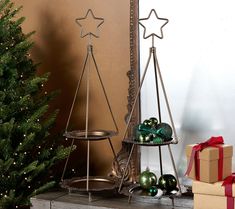 a christmas tree next to a shelf with ornaments on it