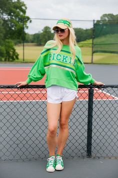 Score a style slam dunk with our Designated Dinker Pickleball Pullover! This playful cropped pullover features a vibrant green striped ribbon and green terry PICKLE lettering. Perfect for adding a touch of fun to your athletic wardrobe. All orders are currently shipping within 14 business days. To receive item quicker, expedited shipping is available at checkout. Green Sporty Sweatshirt, Sporty Green Sweatshirt, Spring Varsity Sweatshirt For Game Day, Green Sports Sweatshirt With Ribbed Cuffs, Green Sweatshirt With Ribbed Cuffs For Sports, Green Tops For Fall Sports Events, Game Day Green Sweatshirt With Team Spirit, Collegiate Sweatshirt For Game Day In Spring, Green Collegiate Sweatshirt For Sports