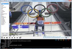 a computer screen shot of a man standing in front of the olympic rings on top of a building