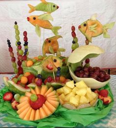 a table topped with fruits and vegetables on top of a green tray covered in fruit