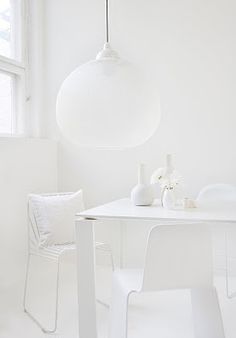 a white room with two chairs and a table