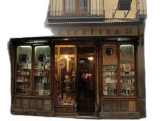 a store front with many items on display in the windows and doors, along with a chair outside