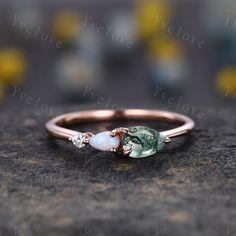 The minimalist Moss Agate & Opal &Moissanite stone design makes this ring suitable for any occasion,styles, and ages. It is perfect for Engagement ring, promise ring anniversary ring birthday gift.This handmade jewelry also can be Customized as you like.This ring is truly unique and a must-have for any green agate gemstone lovers. Setting in alexandrite: www.etsy.com/listing/1218420924/vintage-alexandrite-opal-engagement ITEM SPECIFICATIONS:  925 sterling silver,rose gold plated,white gold plated,yellow gold plated The side stone is CZ Material:Solid gold (10K 14k 18k rose gold,yellow gold,white gold available) Center Stone:6X4mm pear  cut  Moss Agate Stones. Side Stone:4X2.5 pear cut  white fire opal and 2mm round cut  Moissanite stones Band width:approx 2.1mm Setting:pave set Our Service Pear Gemstone Ring, Aesthetic Avocado, Fire Opal Engagement Ring, Magical Decor, Engagement Ring Pear, Smaragd Ring, Random Fashion, September Birthstone Rings, Pear Cut Engagement Rings