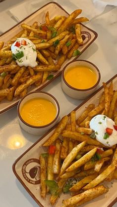 three plates with french fries and dips on them