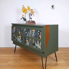 a green cabinet with floral designs on it