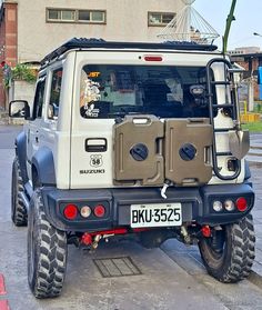 an off - road vehicle parked on the street in front of a building with no doors