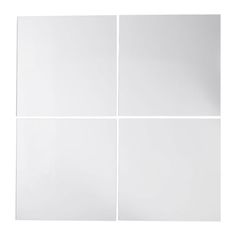 four square white tiles on a white background with no one in the photo looking at them