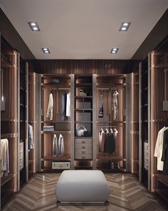 a large walk in closet with lots of clothes