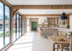 an open kitchen and dining room area with sliding glass doors