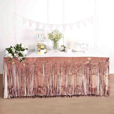 the table is set up with pink and white decorations