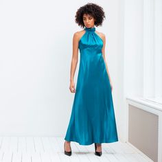 Make a statement with our silk dress in a striking teal hue. Featuring a high-collared neckline, mid-length skirt and a beautiful fit creating a beautiful silhouette. Perfect for weddings, cocktails and holiday occasions. Complement with sandals and a bold earring for an elegant look. This look is the quintessential ready-to-wear item in any coveted wardrobe. Composition: 100% SilkCare: Dry clean only Luxury Green Silk Evening Dress, Silk High Neck Dresses For Parties, Silk High Neck Party Dress, High Neck Silk Party Dress, Elegant Satin Dress With High Neck, Elegant Satin High Neck Dress, Elegant High Neck Satin Dress, Chic High Neck Satin Dress, Silk Halter Dress With Fitted Bodice For Evening