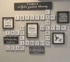 a cross made out of scrabble tiles on the wall with family names and pictures