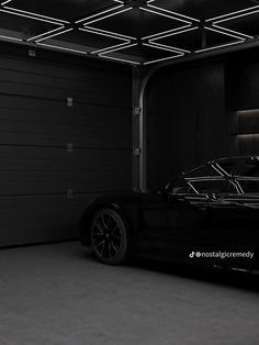 a black sports car parked in a garage with its lights on and the door open