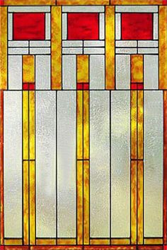 an art deco stained glass window with red and white squares in the center, set against a brown background