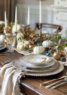 a dining room table set for thanksgiving dinner