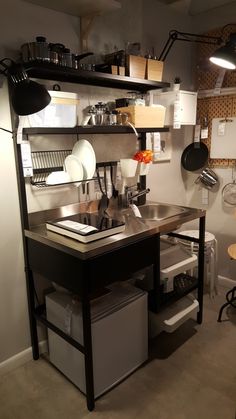 a kitchen area with shelves, pots and pans