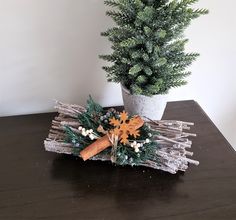 a potted plant sitting on top of a wooden table next to a fake tree