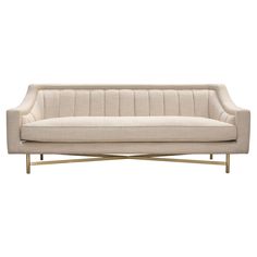 a white couch with gold legs and a beige upholstered back, against a white background