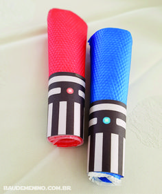 two blue and red tubes sitting next to each other on a white tablecloth covered surface