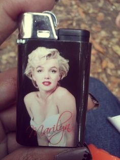 a person holding a lighter with a marilyn monroe photo on it