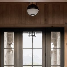 the interior of a house with double doors and windows