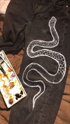 an image of a snake painted on jeans