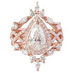 an engagement ring with a pear shaped diamond surrounded by small white and pink diamonds on top