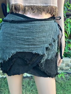 Unleash your inner pirate hippie with our black mini fringe skirt; PuzzleStack's Pirate Pixie Mini Skirt. This playful and edgy skirt features a dynamic fringe design that adds movement and flair to your every step. Perfect for festivals, parties, or casual outings, it’s made from high-quality materials for both comfort and durability. The adjustable waistband ensures a perfect fit, making it a versatile addition to any wardrobe. Embrace the magic and dance freely in this stylish pixie skirt. Tr Fairy Grunge Bottoms For Summer Festival, Fairy Grunge Style Bottoms For Summer Festival, Summer Fairy Grunge Bottoms For Alternative Fashion, Fairy Grunge Bottoms For Summer, Fairy Grunge Mini Skirt For Festival, Gothic Summer Festival Skirt, Summer Festival Gothic Skirt, Hippie Cotton Mini Skirt For Festivals, Hippie Style Mini Skirt For Festivals