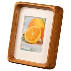 an orange is in a wooden frame on a white background with space for the image