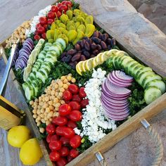 a wooden box filled with lots of different types of vegetables