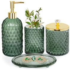 green glass bathroom accessories including soap dispenser, toothbrush holder and vase