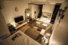 an aerial view of a living room, kitchen and dining area in a small apartment