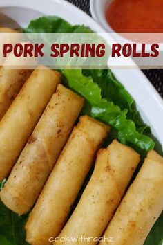 pork spring rolls with lettuce and tomato sauce on the side in a white bowl