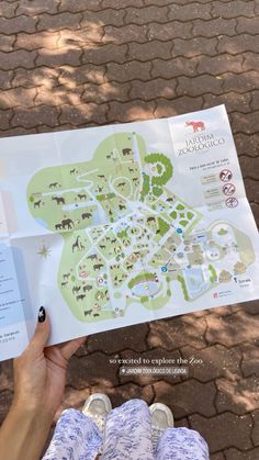 a person holding up a map with animals on it