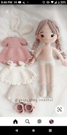 two crocheted dolls are laying next to each other on a white sheet,