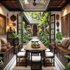 an outdoor dining area with lots of plants and potted plants on the walls, along with wooden tables and chairs