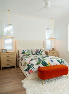 a bedroom with white walls and wooden floors