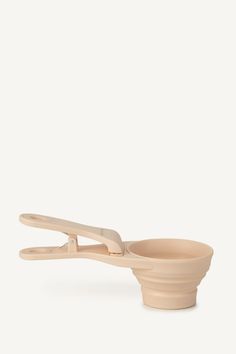 a wooden spoon and bowl on a white background