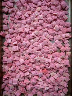 a pan filled with pink marshmallows sitting on top of a table