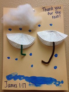 two paper umbrellas are attached to the side of a card that says thank you for the rain