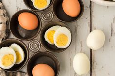 eggs are in small bowls on a white table