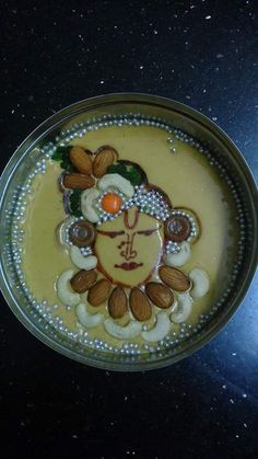 a glass bowl filled with liquid and decorated with an image of a woman's face